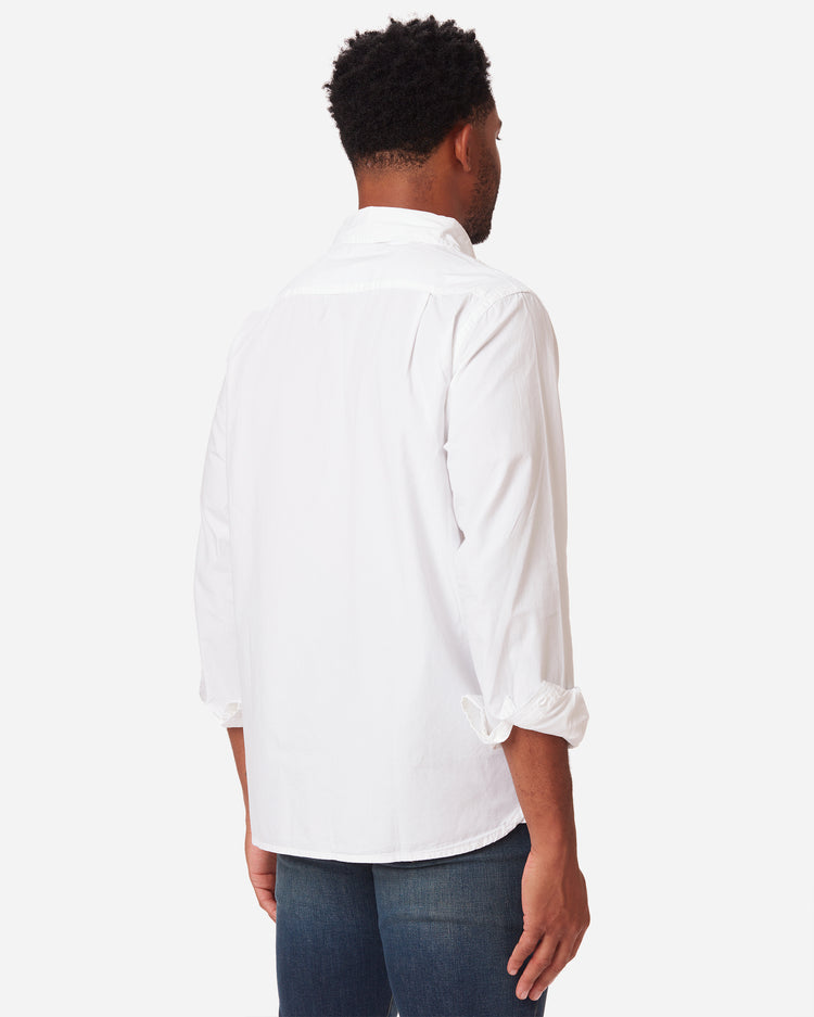 model facing away and rightward wearing men's white long sleeve tailored poplin shirt with color matched buttons and a single pocket in standard height option