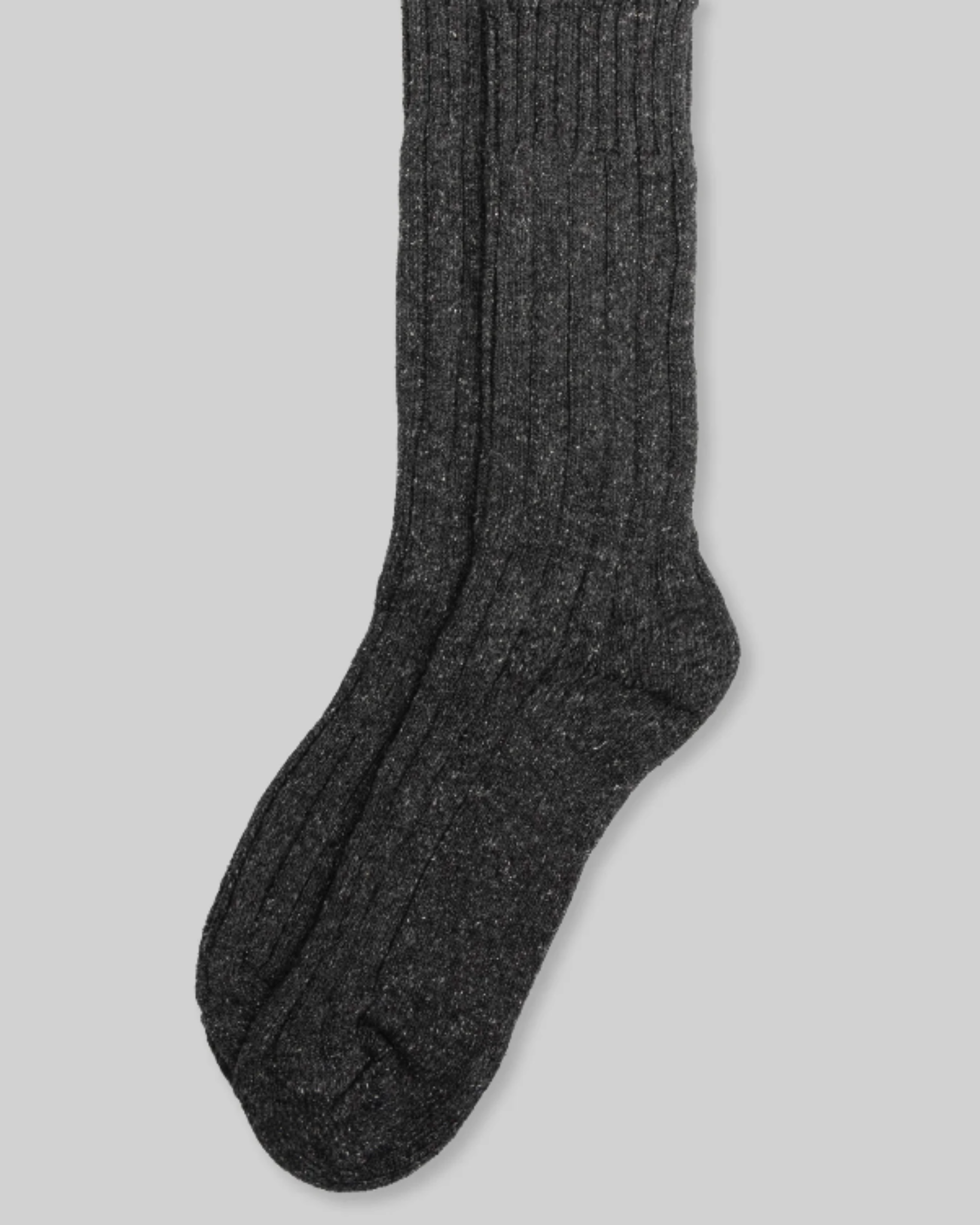 Wool Silk Boot Sock - Charcoal from a top-down perspective, laid flat against a light grey background. The sock features a visible ribbed texture and a heathered charcoal tone. Made from a blend of wool and silk, it looks soft and comfortable, providing warmth and a smooth feel ideal for cold weather.