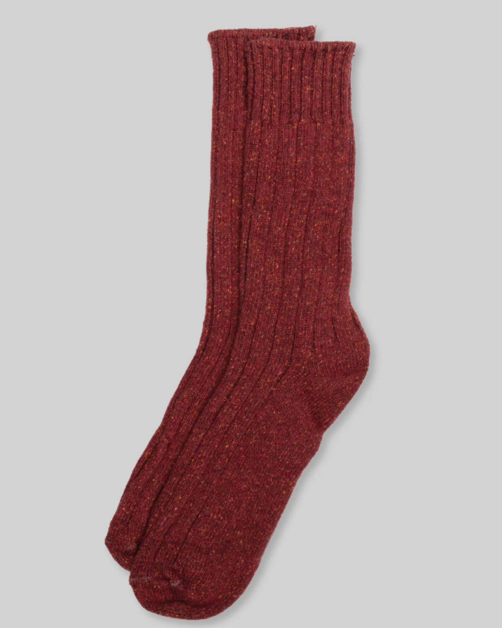 Wool Silk Boot Sock - Rust, displayed flat from a top-down perspective, highlights its ribbed texture and heathered rust color against a light grey background. These socks are crafted from a soft and cozy blend of wool and silk, making them ideal for cold-weather wear.