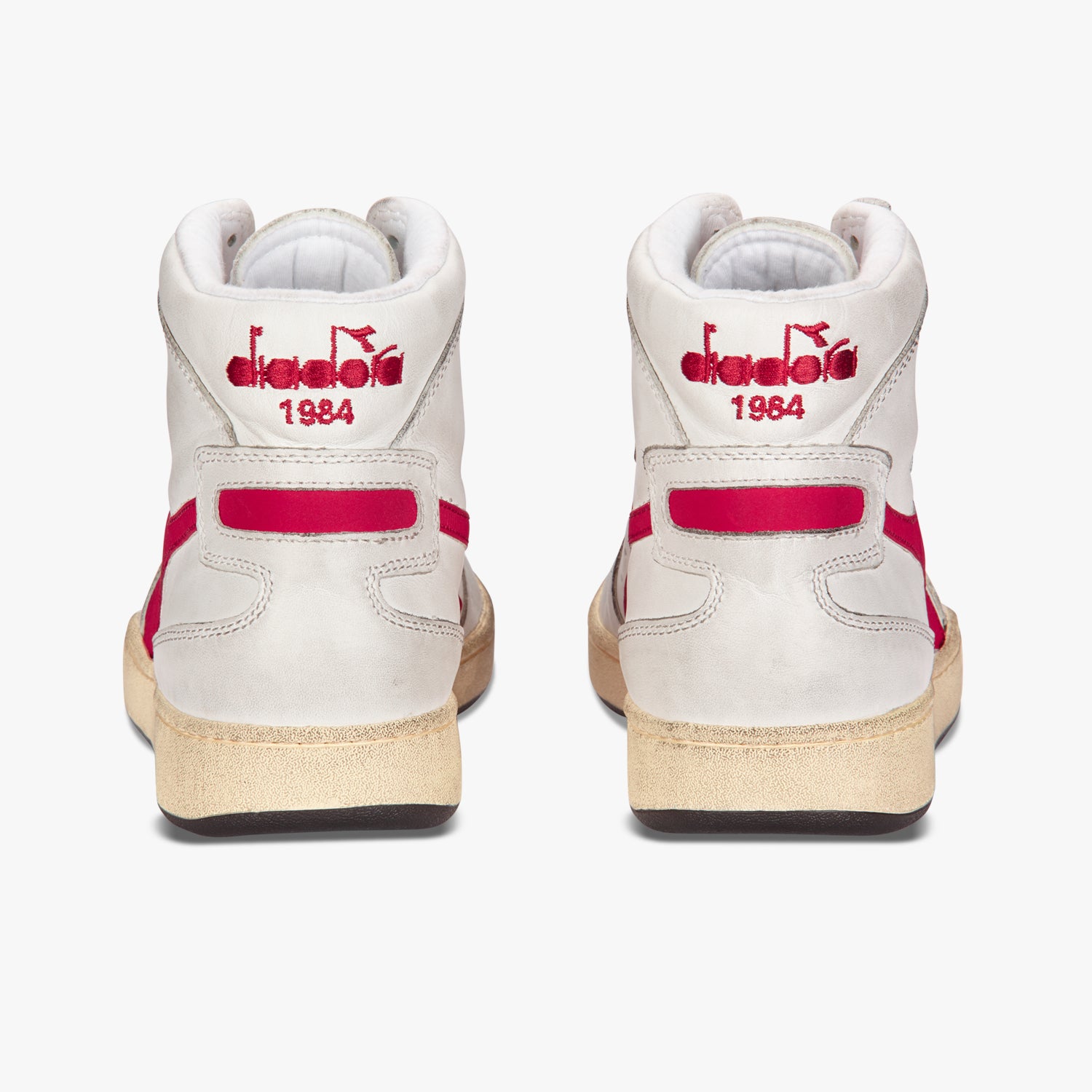side by side view from behind of diadora white mi basket used shoe with red stripe