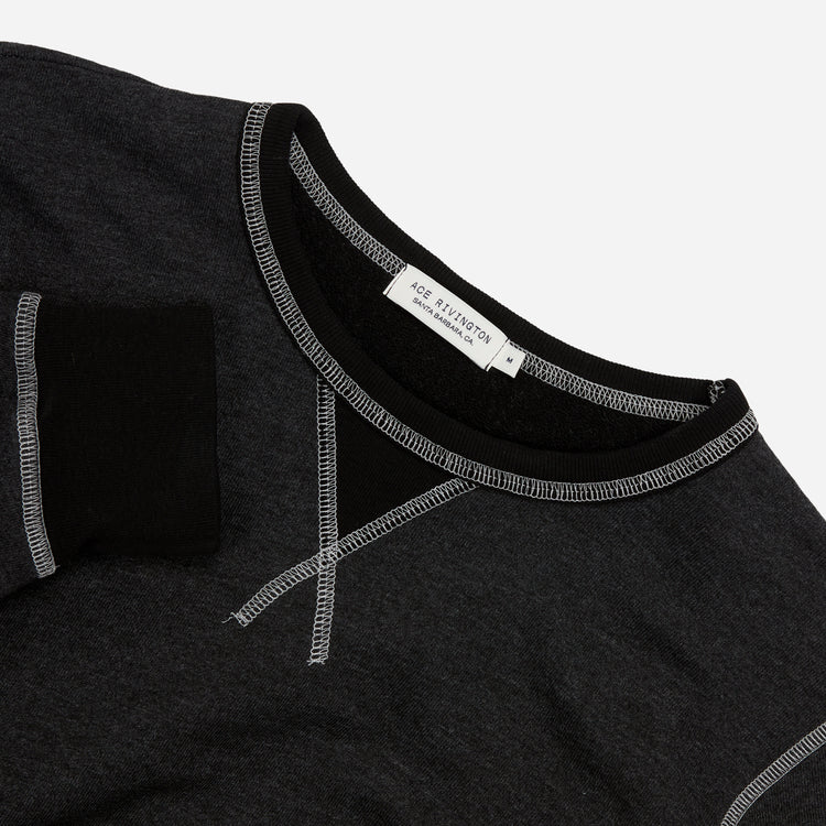 aerial view from above of men's dark grey and black homespun french terry crew neck sweatshirt with white accent stitching with Ace Rivington brand logo in medium