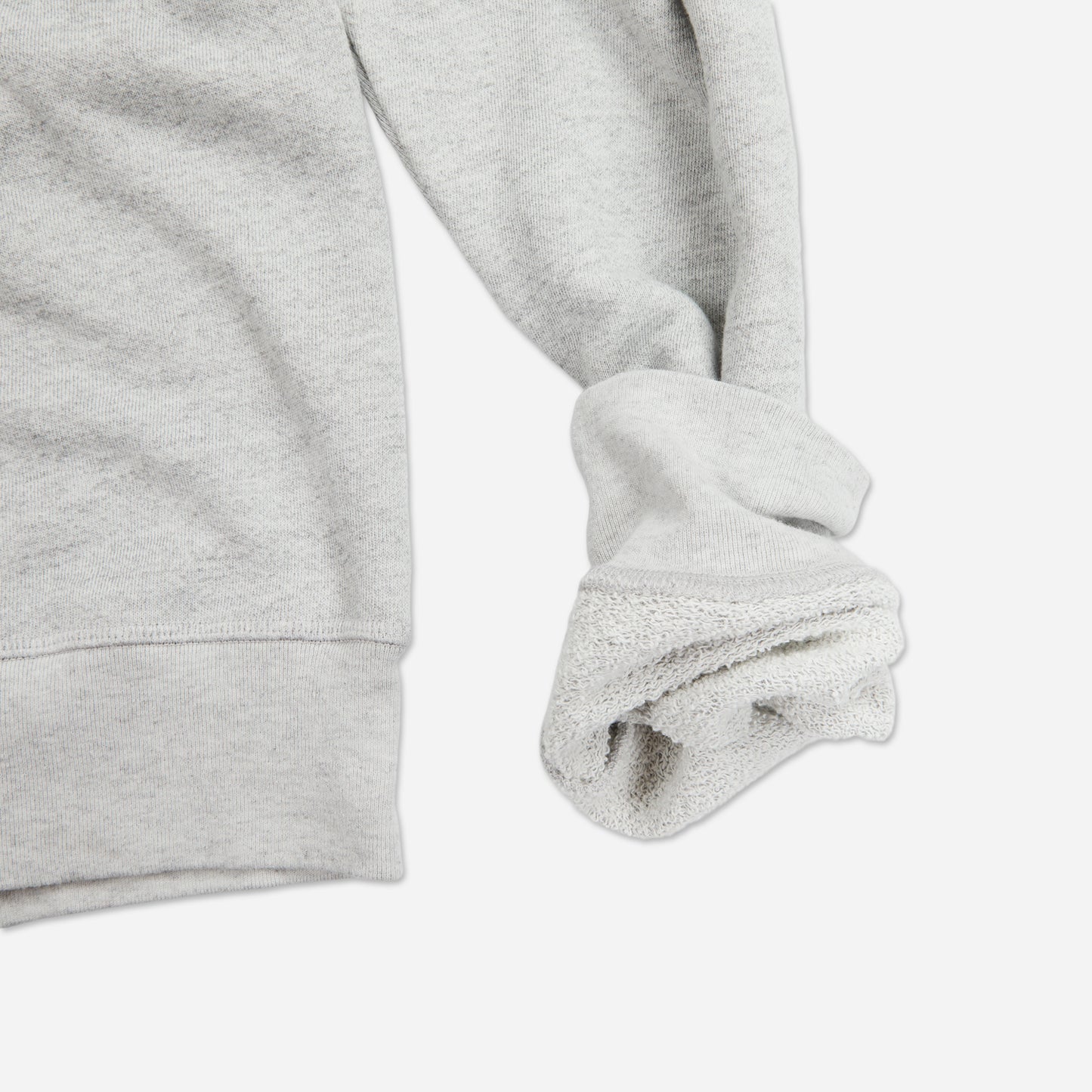 bottom right hand view of off white grey homespun french terry crew neck sweatshirt with white accent stitching with rolled up sleeve