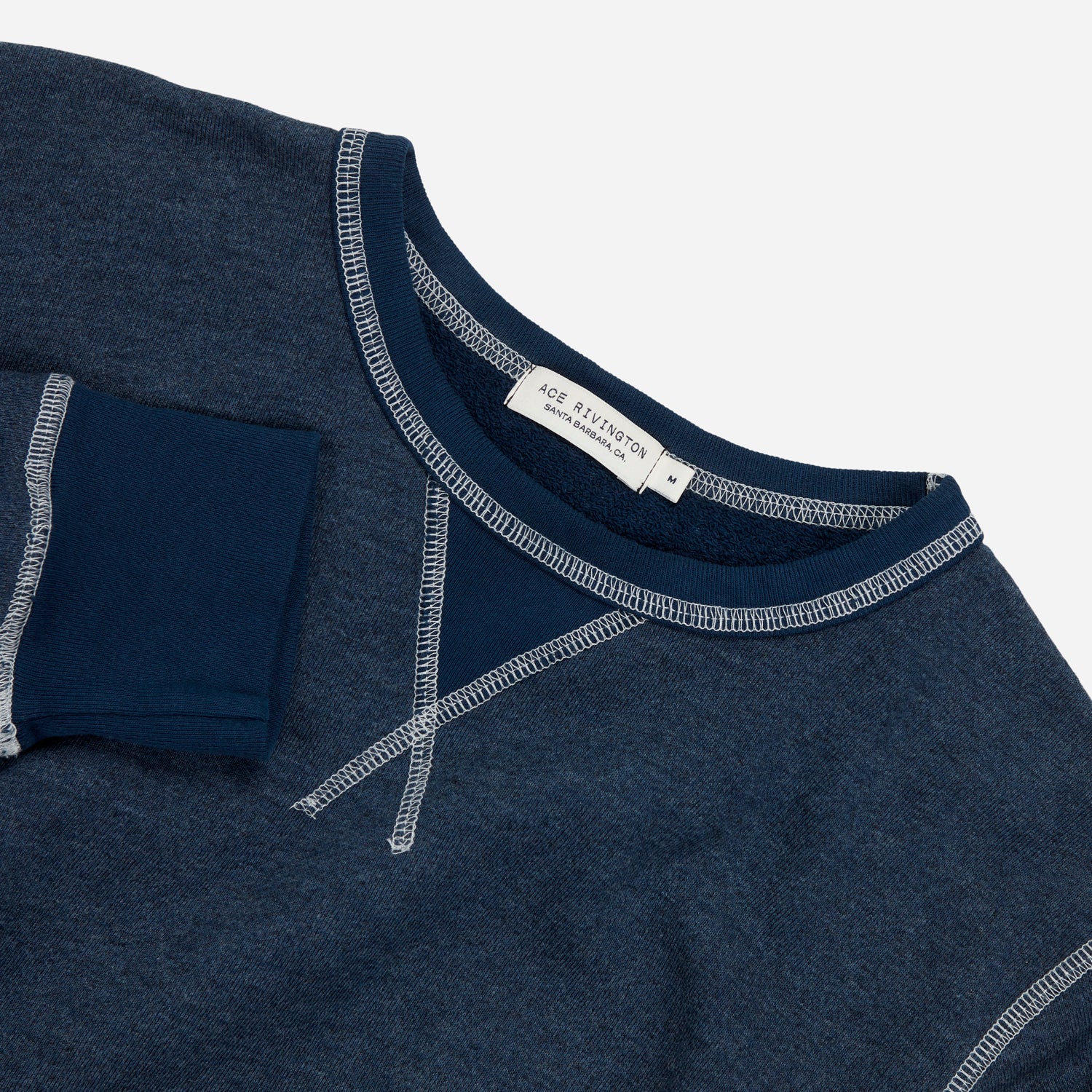 angled aerial view from above of men's navy blue homespun french terry crew neck sweatshirt with white accent stitching and Ace Rivington logo tag in medium