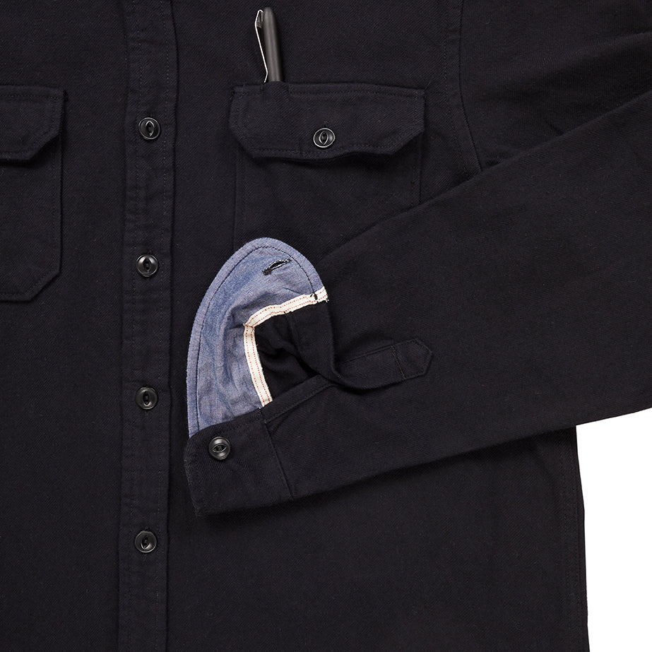 close up of sleeve cuff and breast pocket with pen of men's black winter flannel shirt 