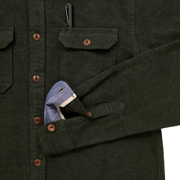 close up of pocket with pen and sleeve cuff on men's forest green flannel with brown buttons and a white collar stripe in standard height option