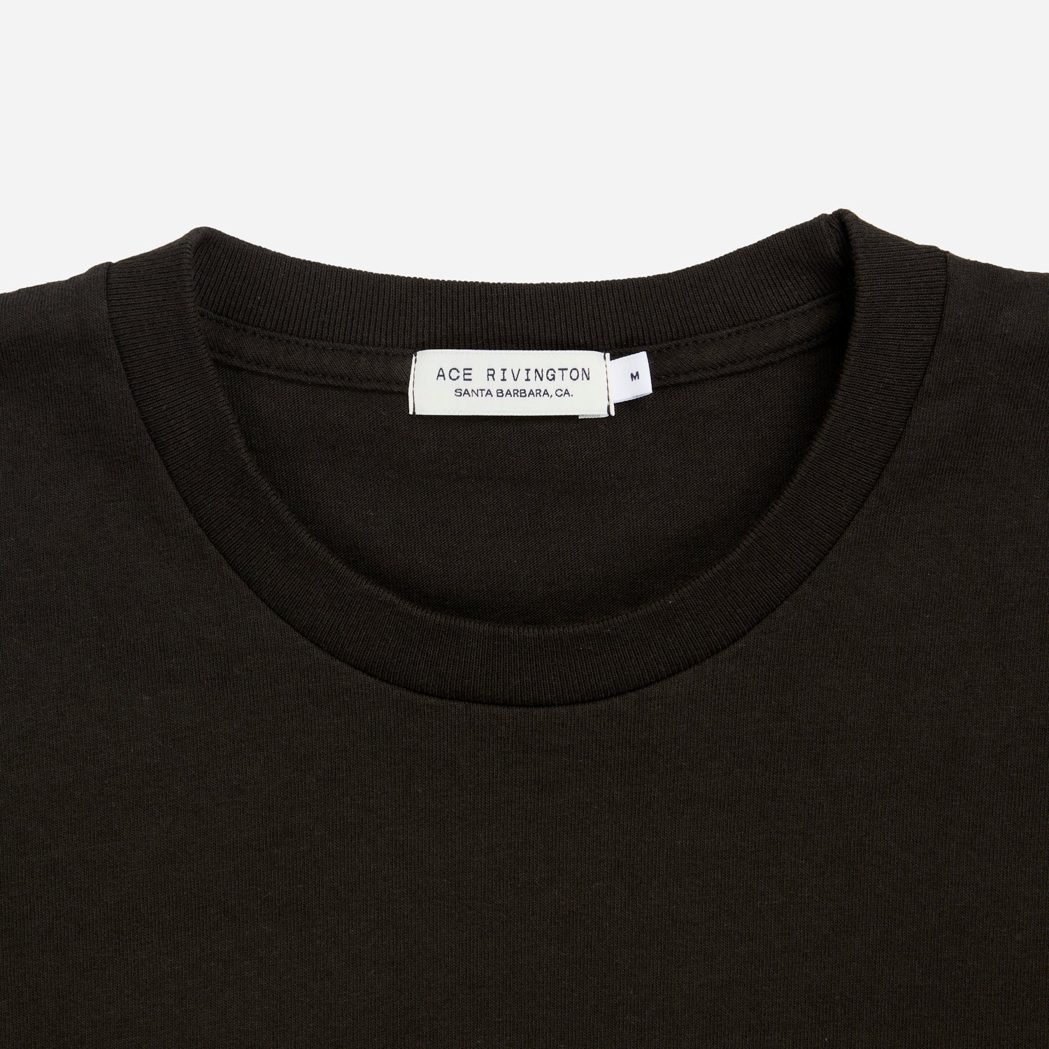zoomed in view of plain black men's t shirt with Ace Rivington brand logo in medium