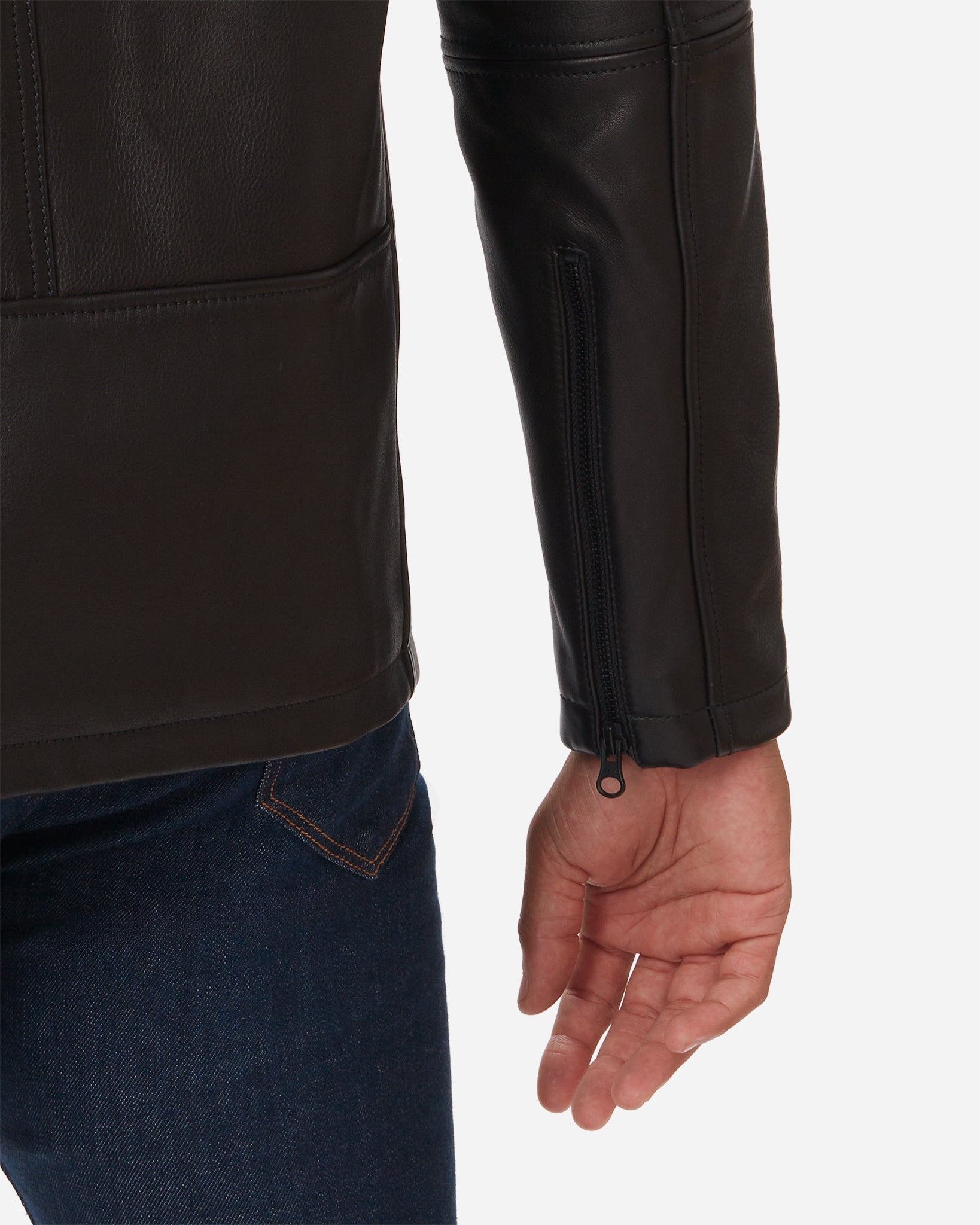 A close-up view of a man wearing a Cowhide - Cafe Racer - Vintage Black Jacket and dark blue jeans. The focus is on the lower back and right arm of the jacket, which features a zipper on the sleeve. The man's right hand is visible, hanging by his side.