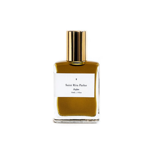 A rectangular bottle with a golden cap of Ace Rivington Saint Rita Parlor - Signature Parfum contains 15 mL (0.5 fl oz.) of perfume.