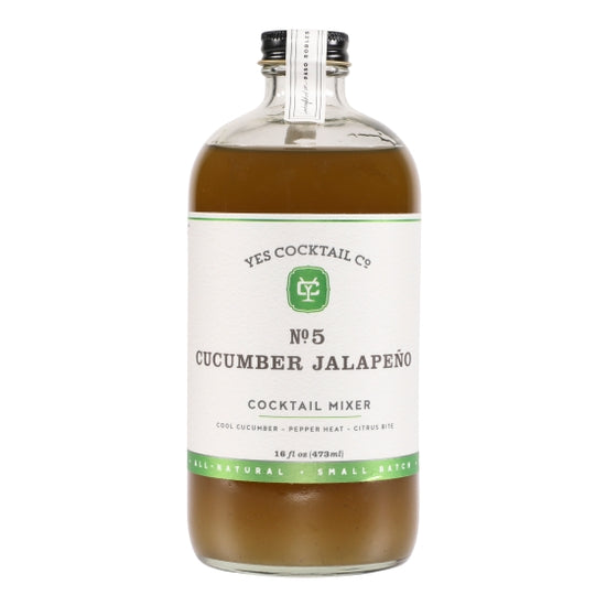 A bottle of Ace Rivington Yes Cocktail Co - Cucumber Jalapeno Mixer. The bottle is clear with a white label featuring green and black text. The label reads 'YES COCKTAIL CO. No. 5 CUCUMBER JALAPEÑO COCKTAIL MIXER' and describes the flavor as 'Cool Cucumber - Pepper Heat - Citrus Bite.' The bottle contains 16 fl oz (473 ml) of the mixer and is labeled as 'All-Natural' and 'Small Batch.' The bottle has a black cap with a white seal on a plain white background.