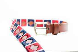 front extending view of tan alternating blue and red diamond pattern belt with a gold buckle