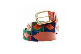 front coiled view of tan, white, blue and green western style belt with diamond patterns and gold buckle