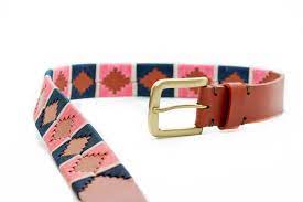 extending view of tan belt with green and pink alternating diamond pattern and gold buckle