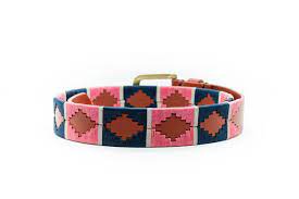 back coiled view of tan belt with green and pink alternating diamond pattern and gold buckle