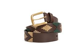 front coiled view of dark brown belt with dark green and beige diamond patterns and a gold buckle