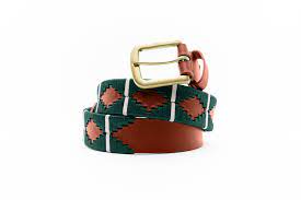 front coiled view of tan belt with dark green diamond patterns and white stripes with a gold buckle