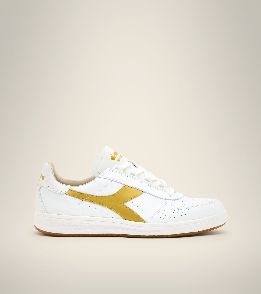 side view of white and gold B. elite h italia sport diadora shoe made in italy