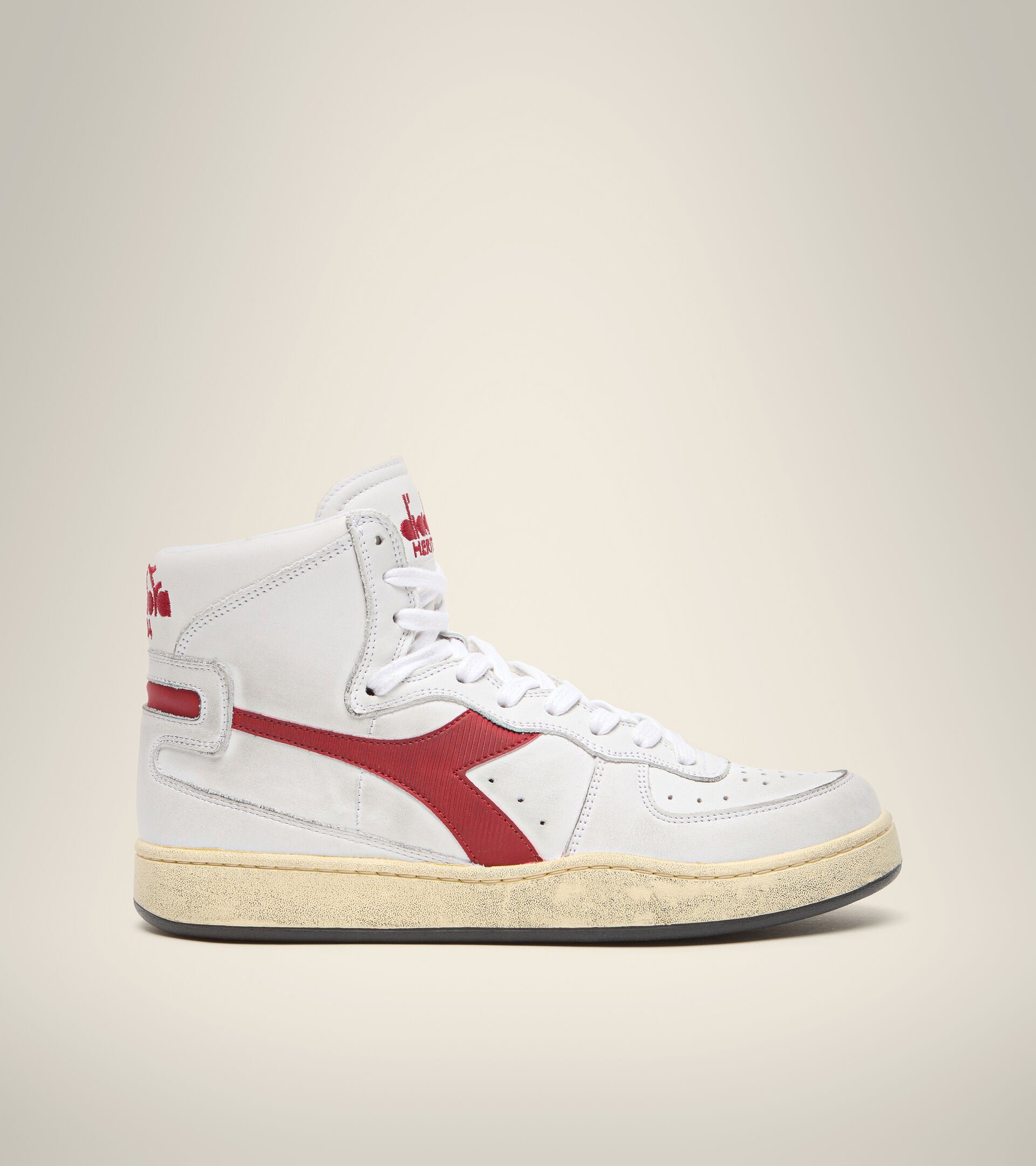 side view of diadora white mi basket used shoe with red stripe