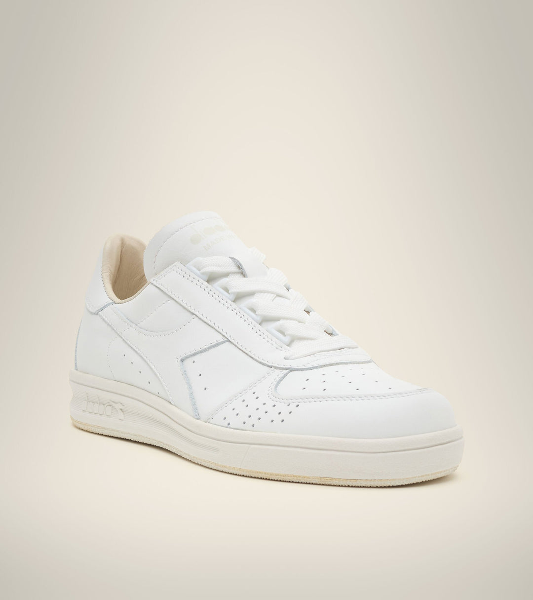 single angled side view of white on white B. elite h italia sport diadora shoe made in italy